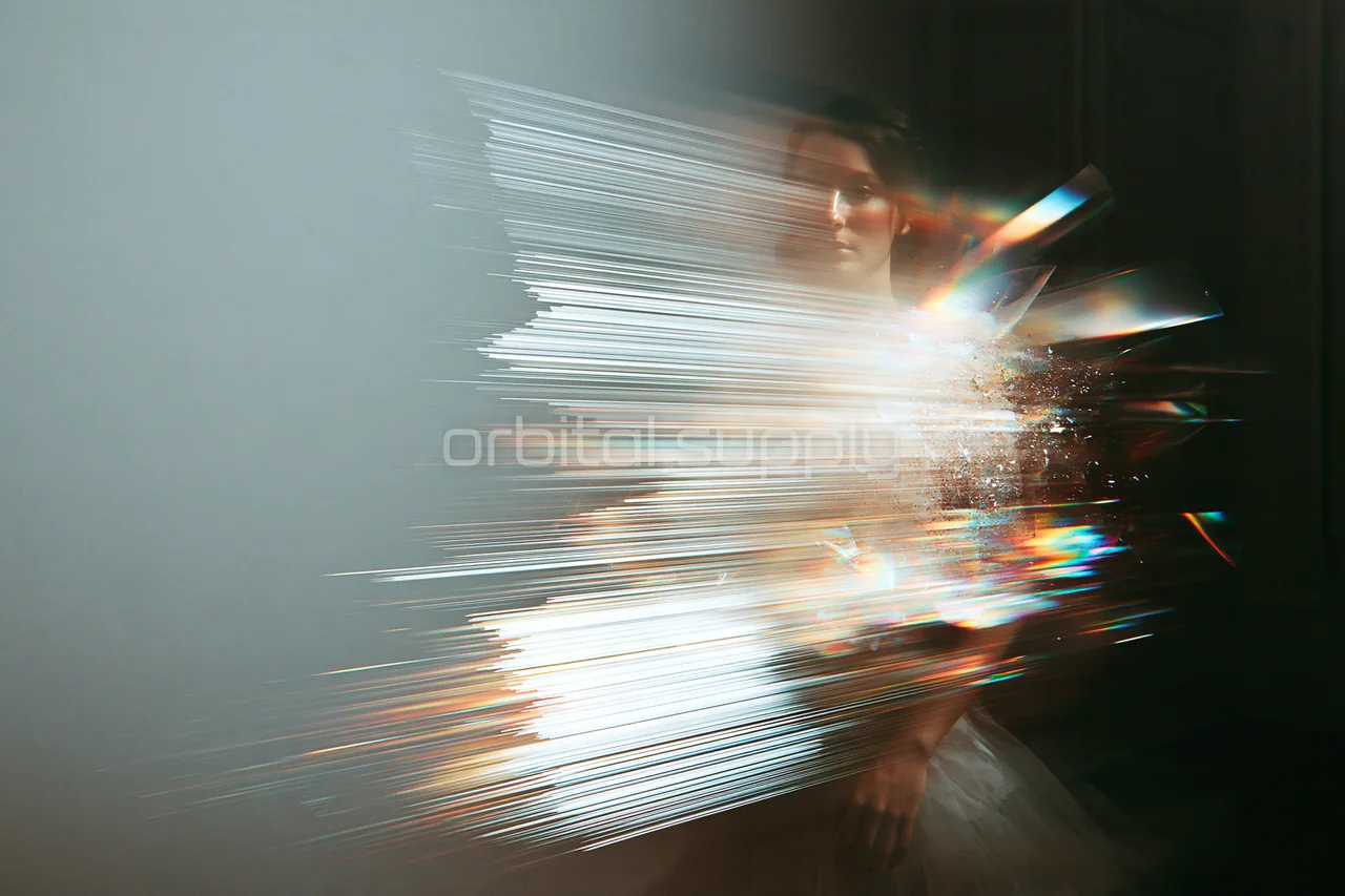 Dense silver-white horizontal fragments partly dissolve a figure against a muted background.