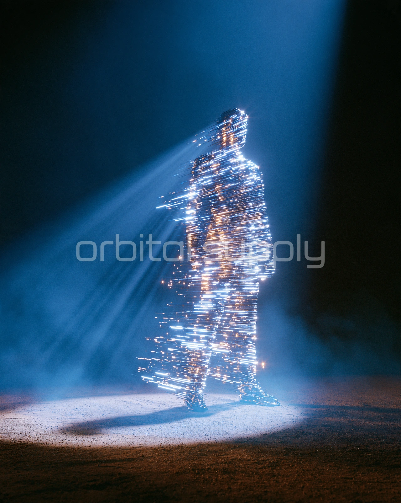 A human silhouette made of white and gold light streaks stands alone in a beam of light.